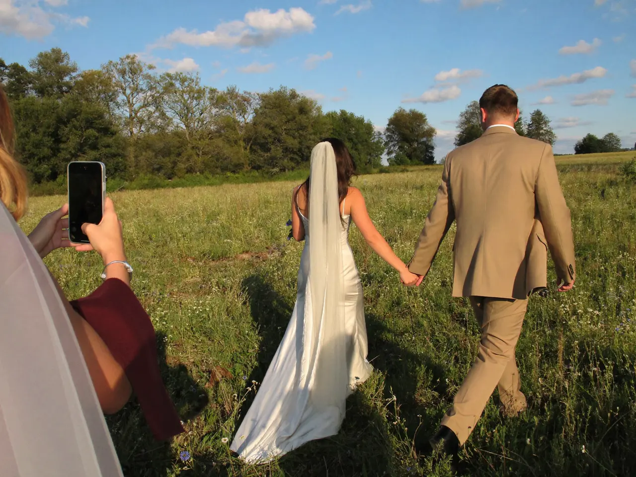 The couple walking across the meadow
