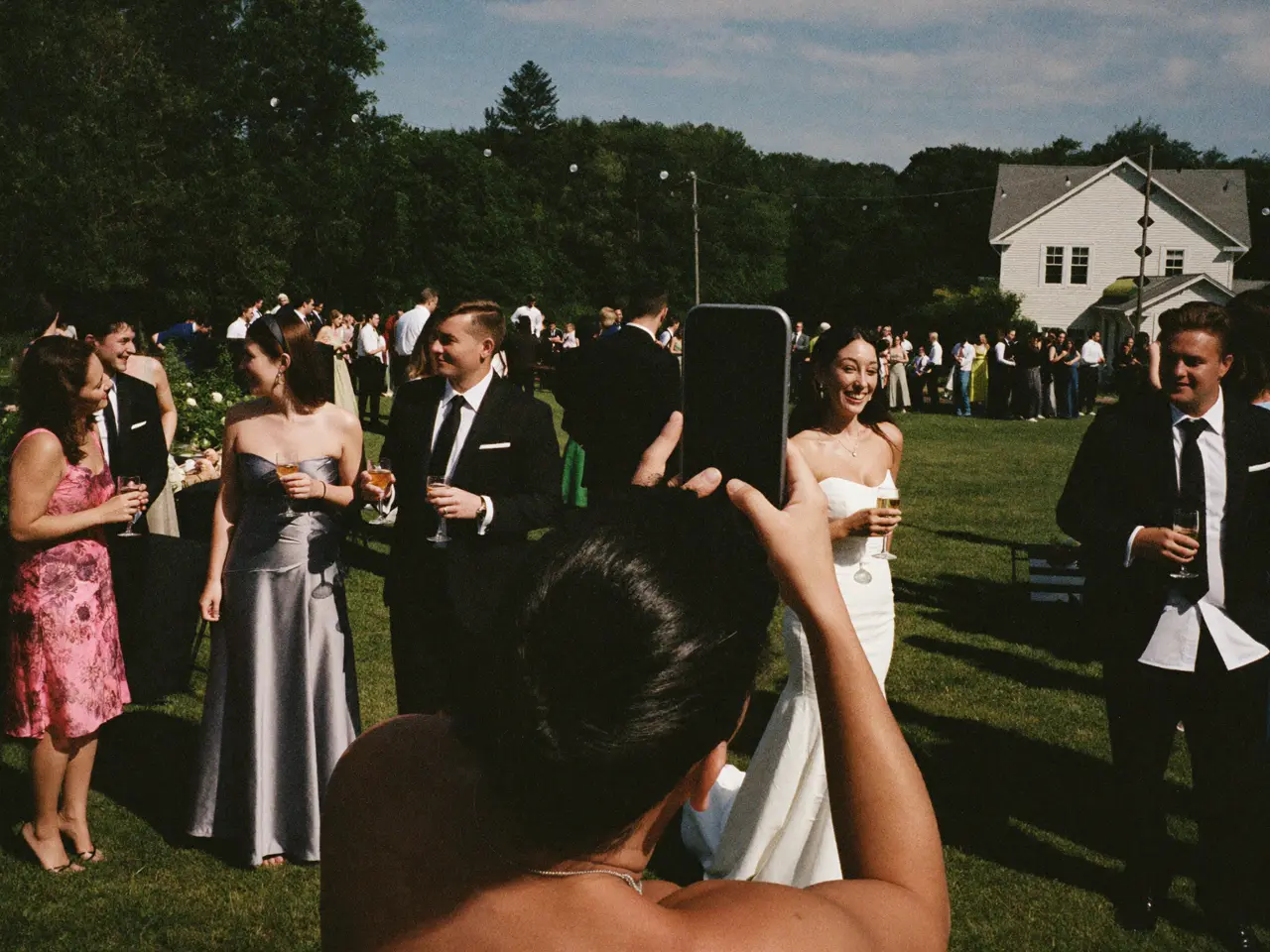 Guests mingling on the lawn at golden hour
