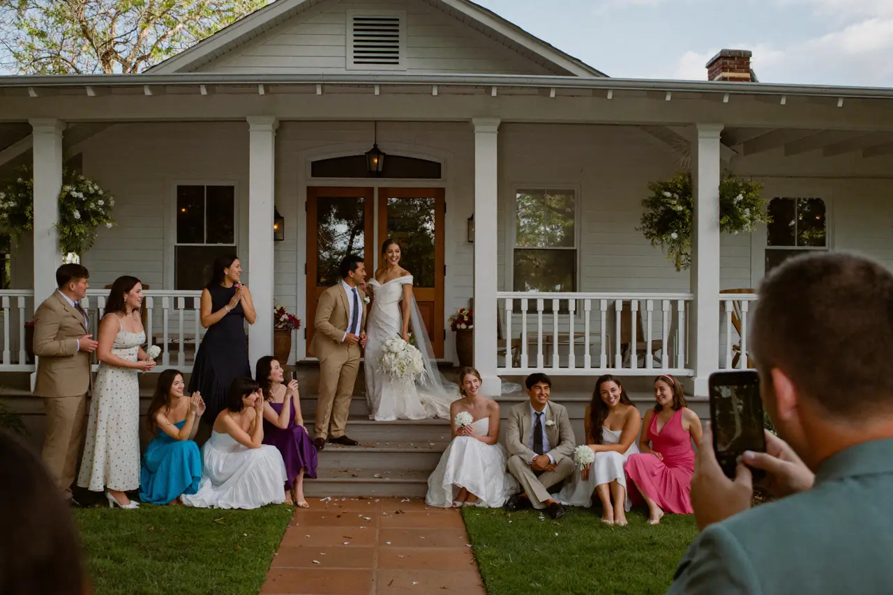 The group photo on the farmhouse porch