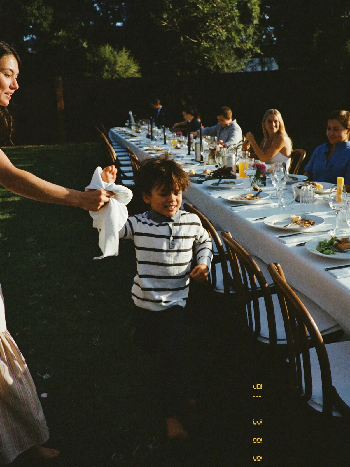 Children running between the tables while the adults eat