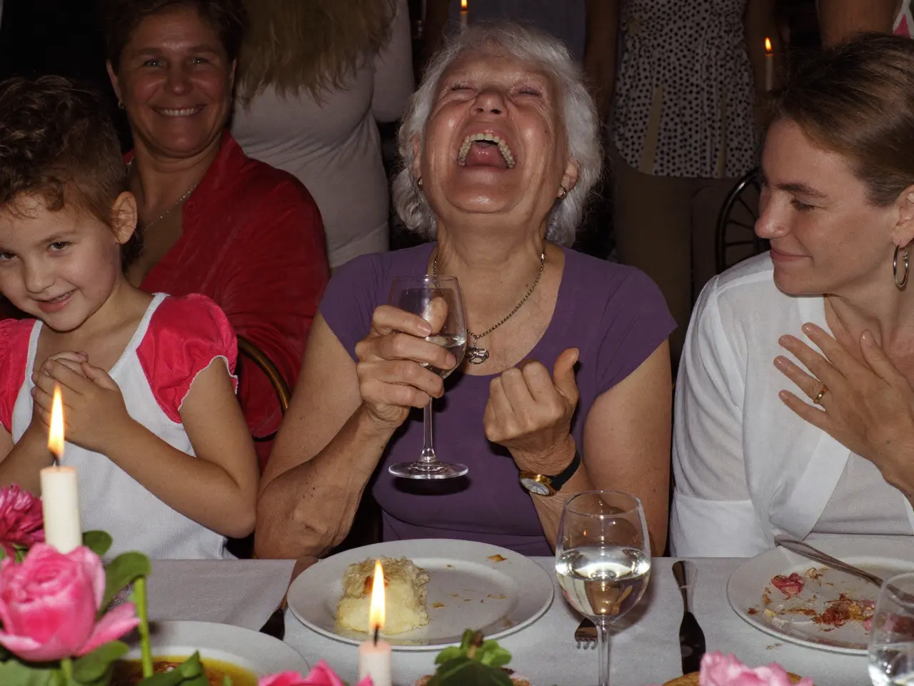 Grandma laughing at the dinner table