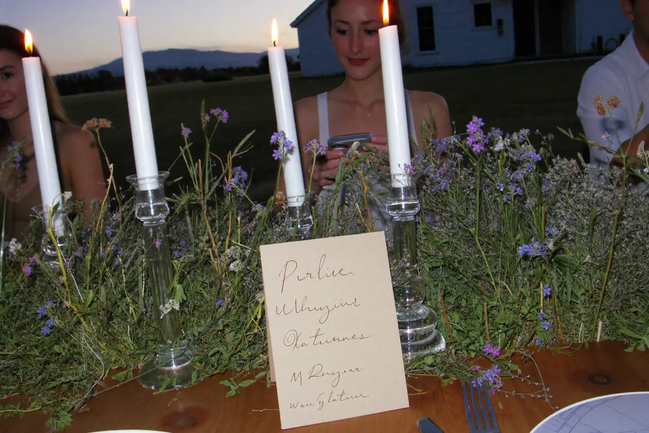 Printed QR code for wedding photos on a reception table at dusk