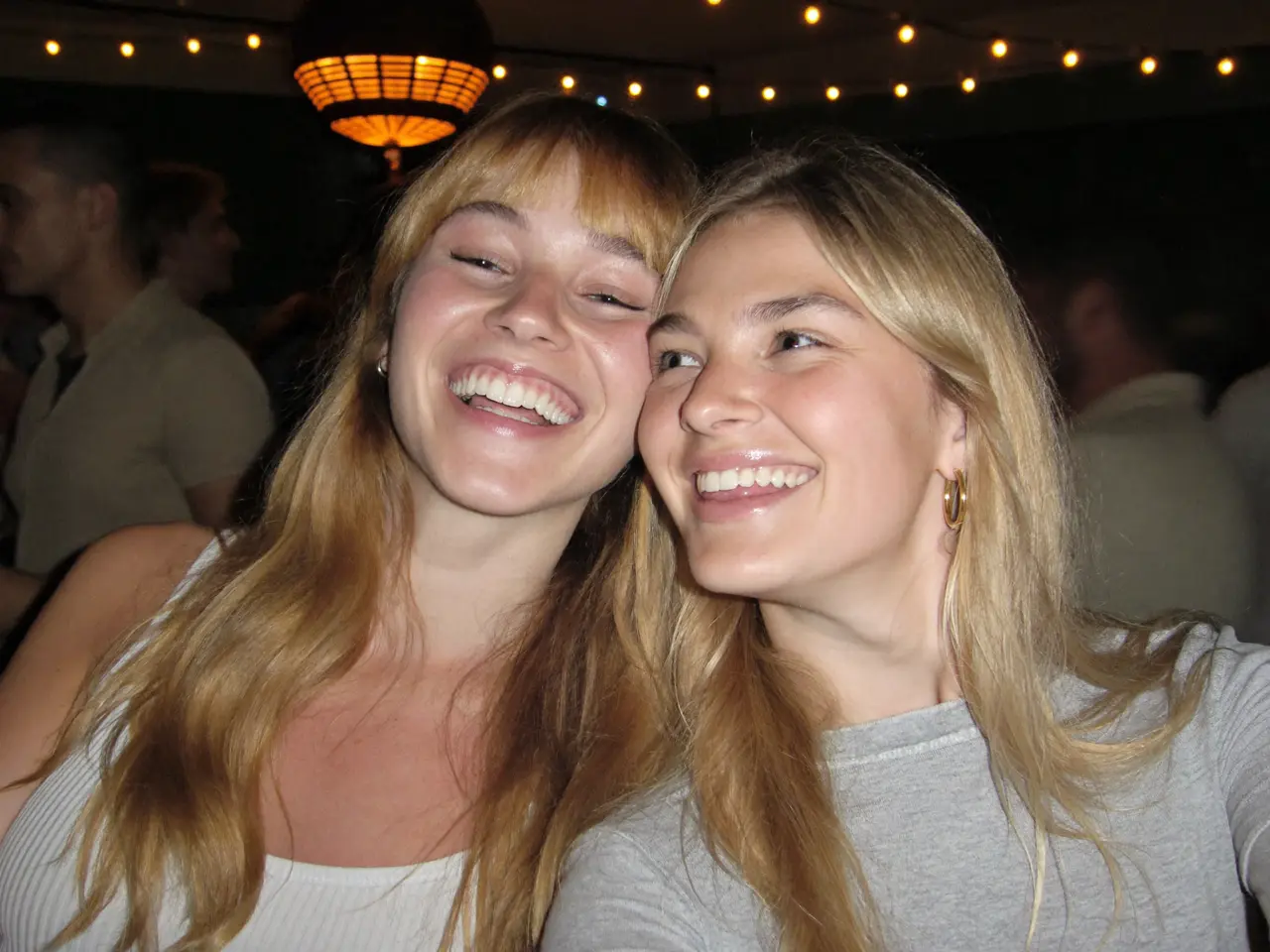 Rachel laughing with a friend at the party